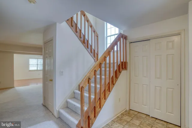 a view of staircase with lots of frames on wall and stairs