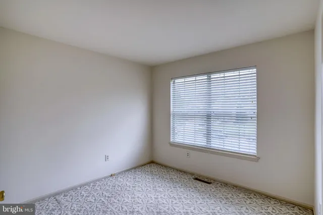 a bathroom with a granite countertop sink toilet and a mirror