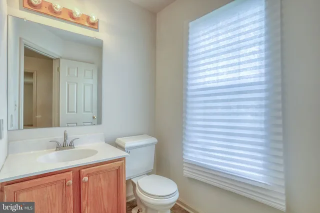 a view of a house with backyard and a tree