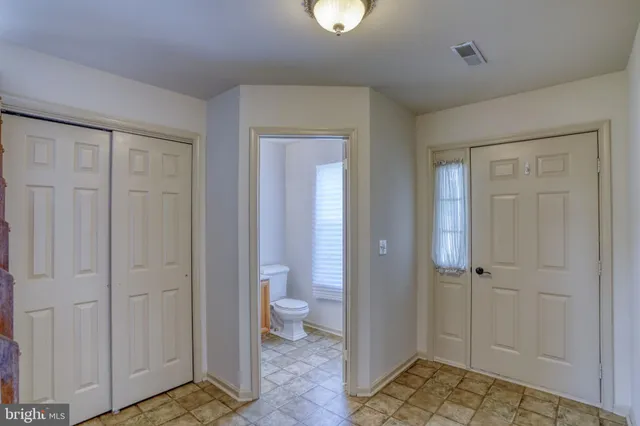 a view of empty room with a fireplace