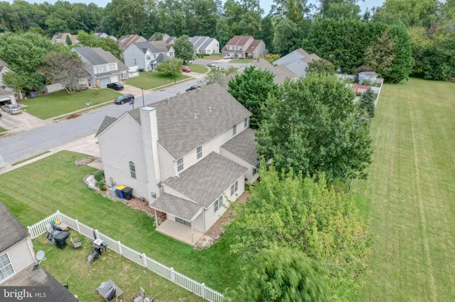 a front view of a house with a garden and plants