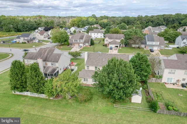 an aerial view of a house with garden space and street view