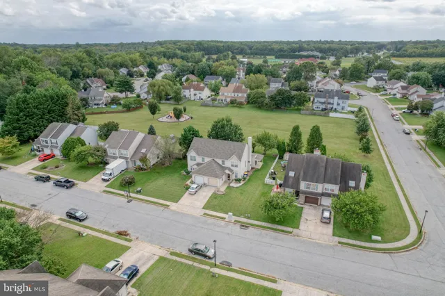an aerial view of a house with outdoor space and street view
