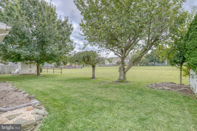 a view of a house with a door and wooden bench