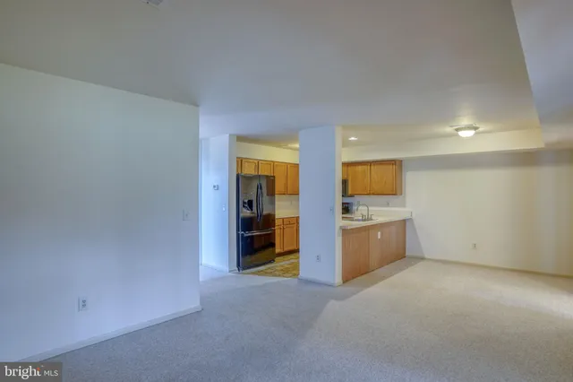 a kitchen with stainless steel appliances a refrigerator and a stove top oven