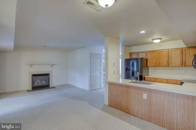 a kitchen with stainless steel appliances a refrigerator and cabinets