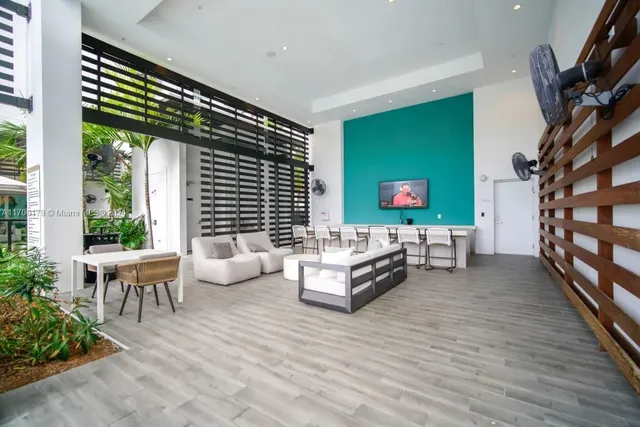 a view of a patio with couches chairs and a big yard