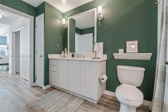 a bathroom with a double vanity sink toilet and shower