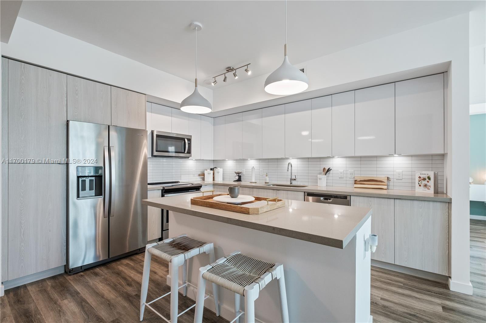 1919 Southeast 10th Avenue, Unit 2130 Fort Lauderdale, FL 33316 - Photo 24 of 35 a kitchen with stainless steel appliances granite countertop a stove refrigerator sink and cabinets