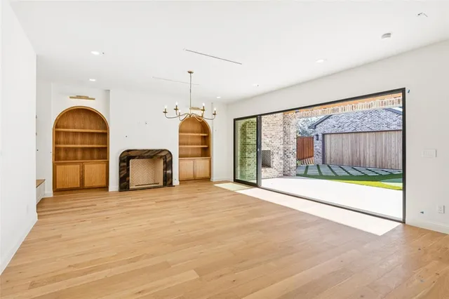 a view of empty room with floor to ceiling window and outdoor view