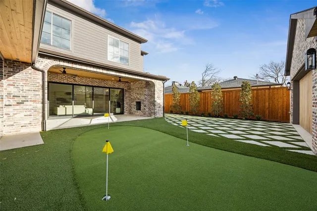 a view of a house with backyard and porch