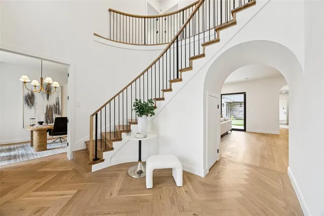 a view of staircase with wooden floor and a rug
