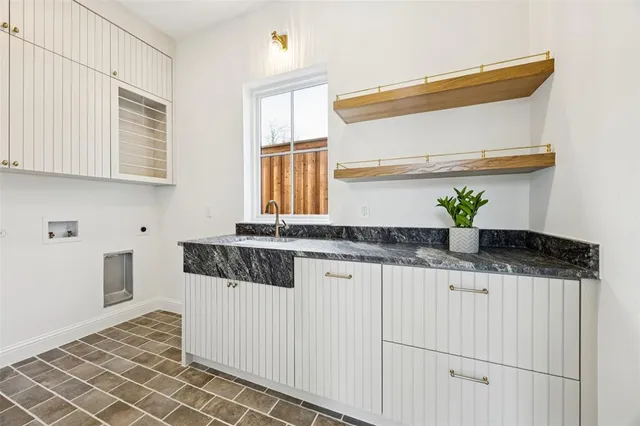 a kitchen with stainless steel appliances a sink and a window