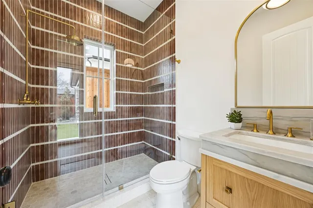 a bathroom with a sink toilet and shower