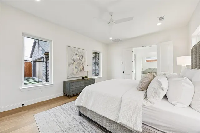 a bedroom with a large bed and a window