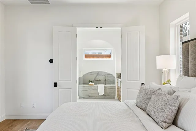 a bedroom with a bed and a painting on the wall