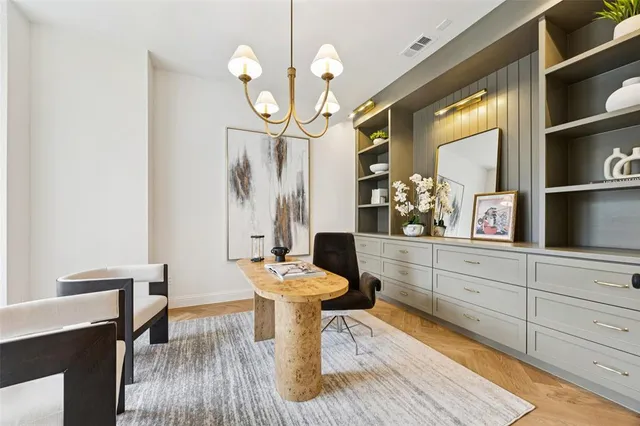a dining room with wooden floor a glass table and chairs