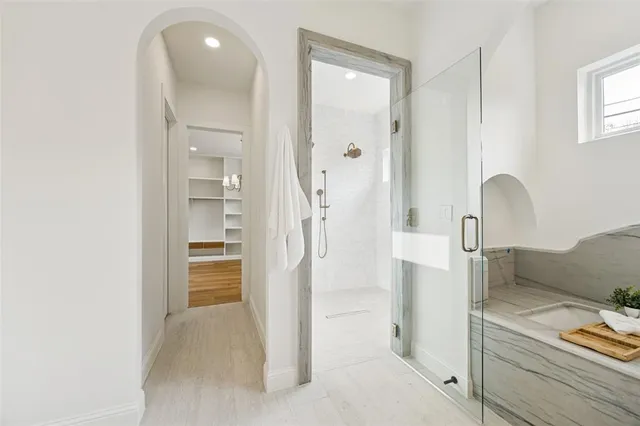 a bathroom with a tub shower and sink