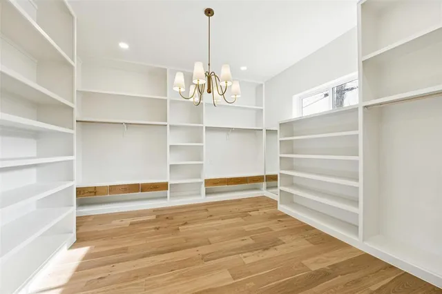a view of walk in closet with empty racks