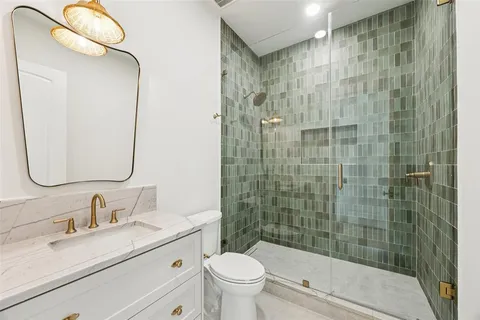 a bathroom with a sink toilet and shower