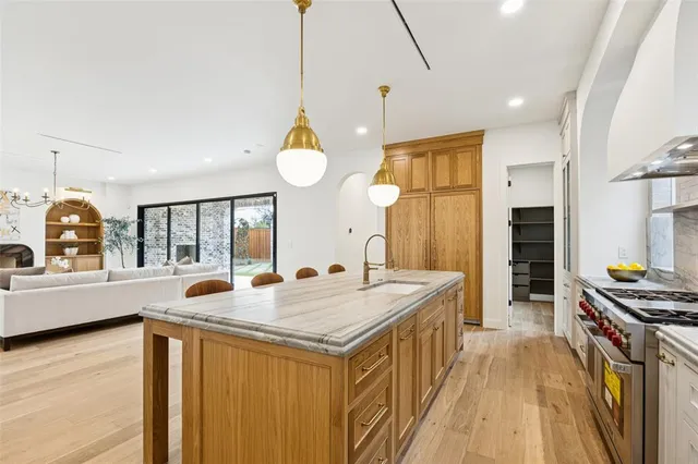 a kitchen with sink refrigerator and cabinets