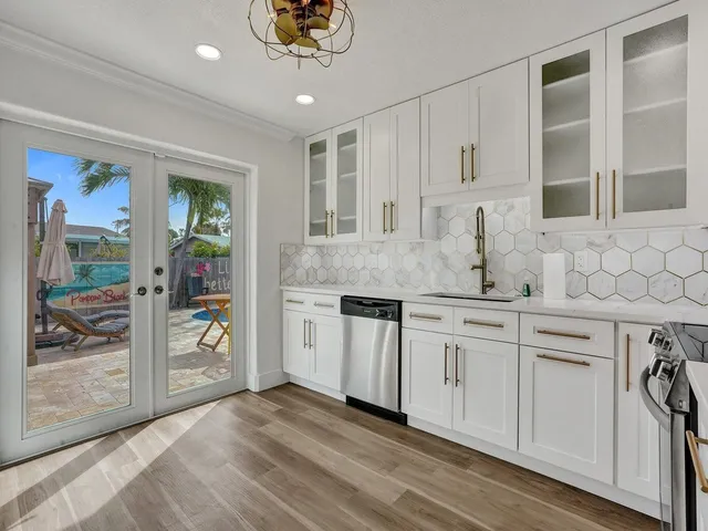 a kitchen with stainless steel appliances granite countertop a lot of counter space and wooden floors