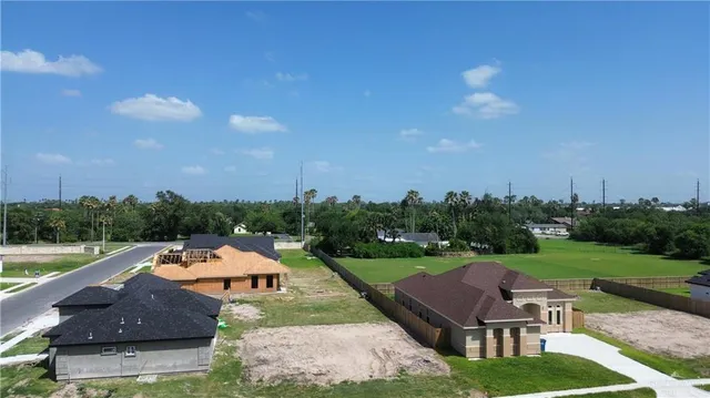 an aerial view of a house with garden space and street view