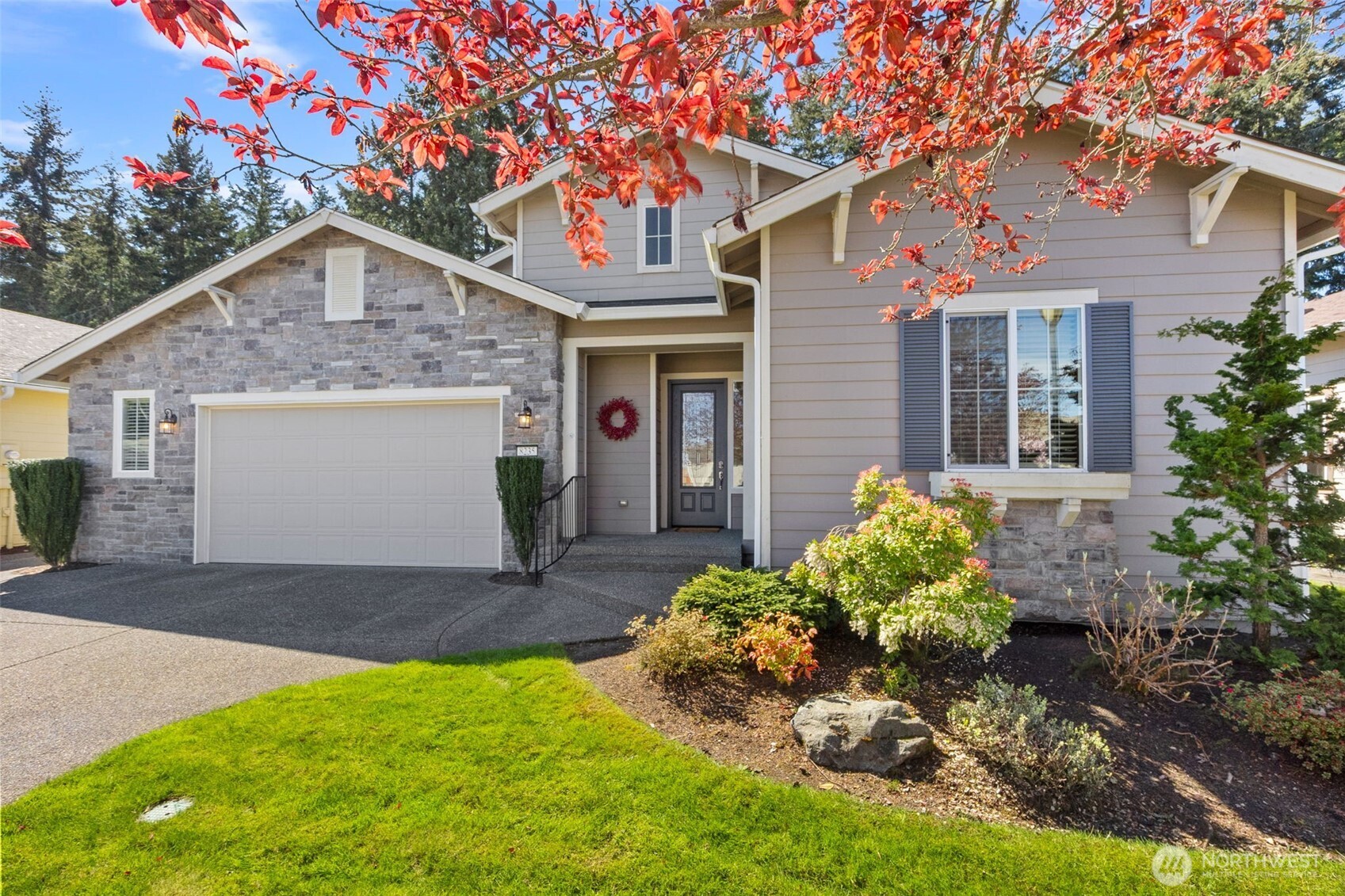 a front view of a house with a yard and garage