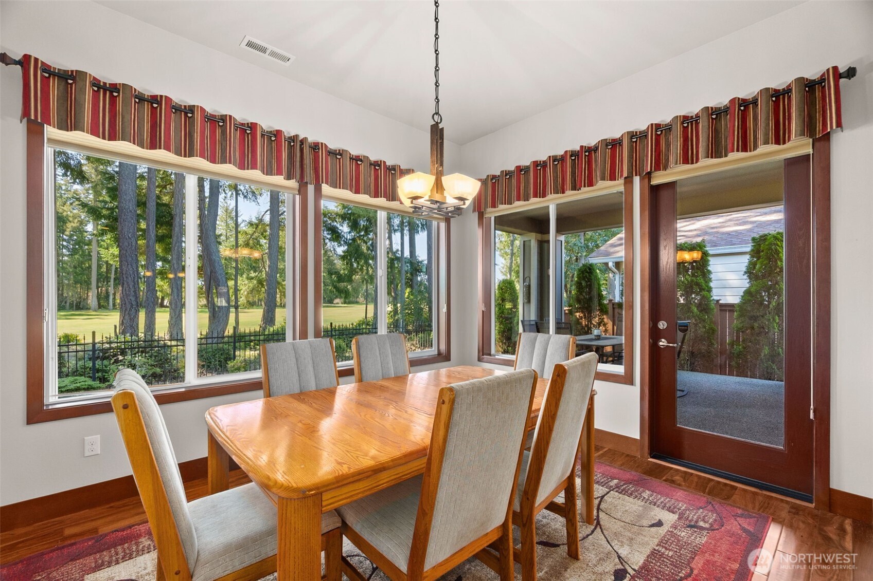 8235 Orcas Loop Northeast Olympia, WA 98516 - Photo 18 of 39 a dining room with furniture large windows and wooden floor