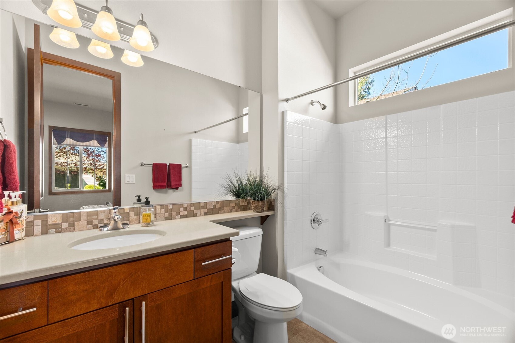 8235 Orcas Loop Northeast Olympia, WA 98516 - Photo 21 of 39 a bathroom with a sink a toilet a mirror a bathtub and shower