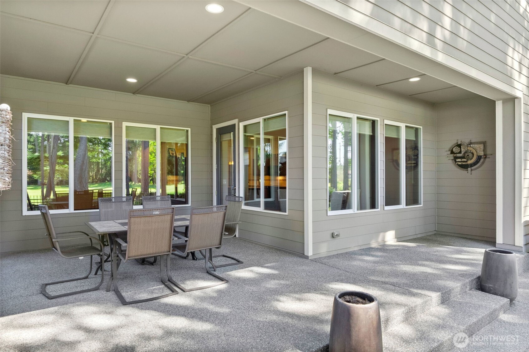 8235 Orcas Loop Northeast Olympia, WA 98516 - Photo 33 of 39 a view of a patio with table and chairs and floor to ceiling window