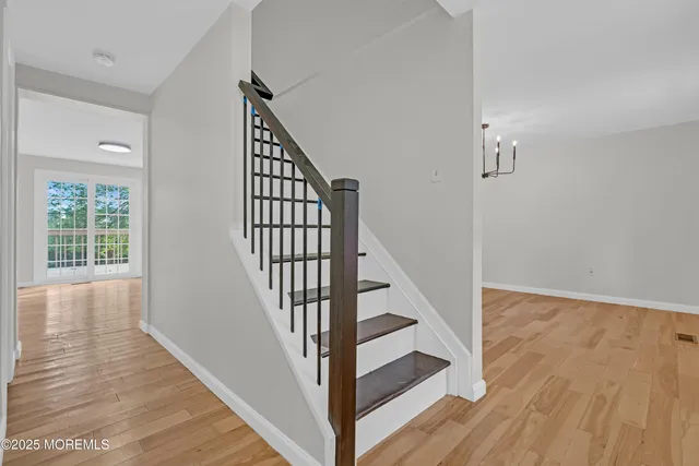 a view of staircase with white walls and railing