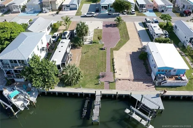 an aerial view of a house with a yard swimming pool and outdoor seating