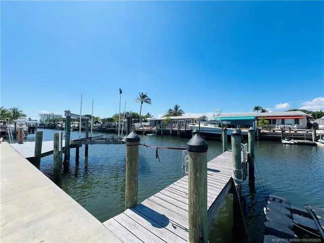 a view of a lake with boats and trees in the background