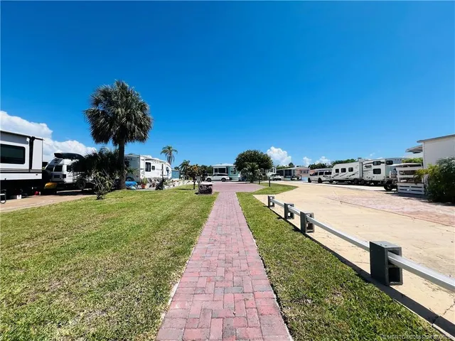 a view of park with multi story residential apartment building with a yard