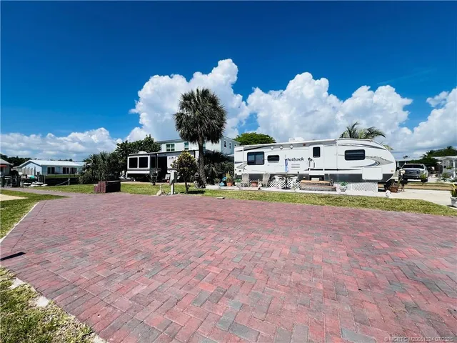 a front view of a building with parked cars