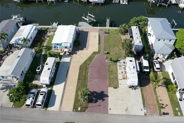 an aerial view of a house with outdoor space and lake view