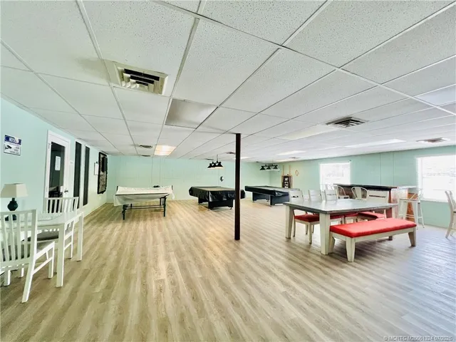 a view of a dining room with furniture wooden floor and chandelier