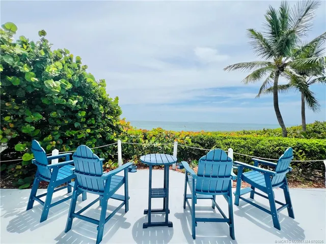 a view of a deck with a table and chairs