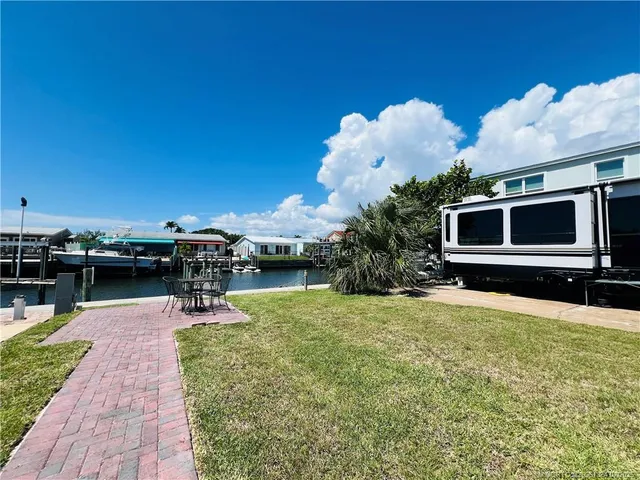 a swimming pool with outdoor seating and a garden