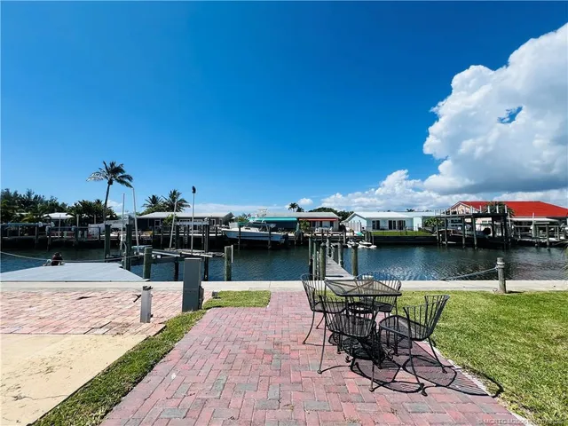 a swimming pool with outdoor seating and yard