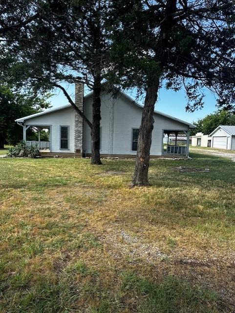 6294 Dugan Chapel Road Bells, TX 75414 - Photo 2 of 38 a house that has a tree in front of it