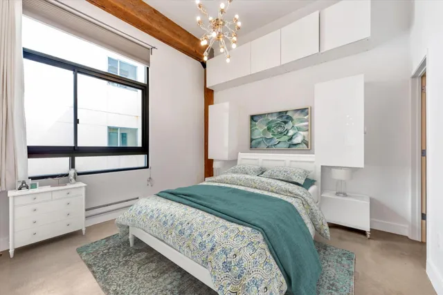 a bedroom with a large bed and a window