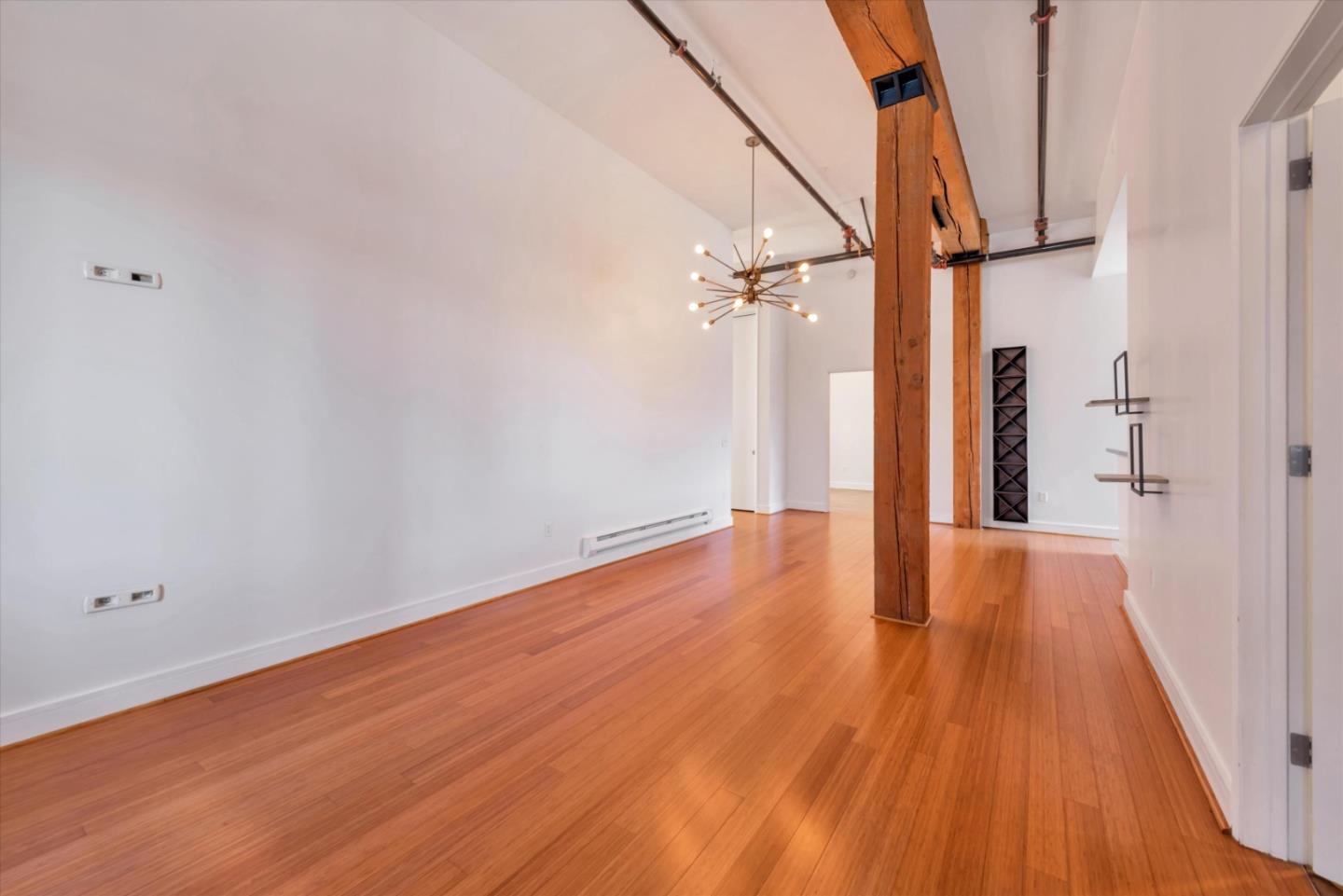 310 Townsend Street, Unit 305 San Francisco, CA 94107 - Photo 6 of 30 a view of empty room with wooden floor and fan