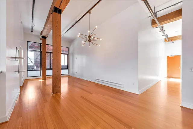 a view of an entryway with wooden floor