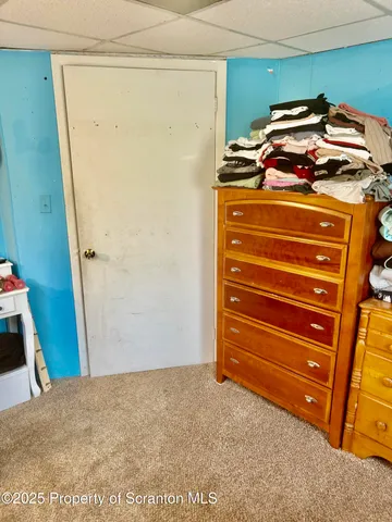 a bedroom with a bed and flat screen tv
