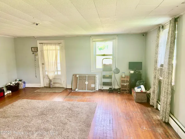 a view of a room with gym equipment and a large window