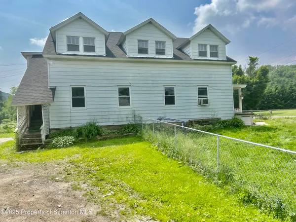 a backyard of a building with lawn chairs