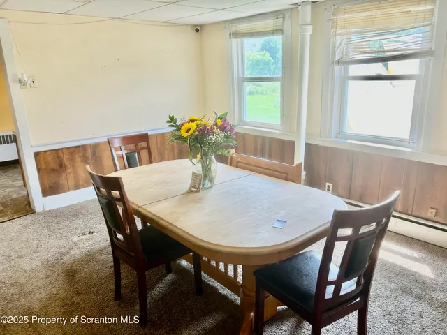a view of a dining room with furniture and window