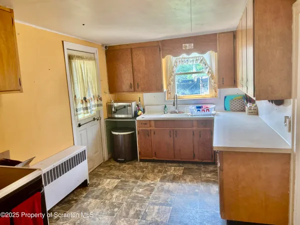 a kitchen with a sink stove and cabinets